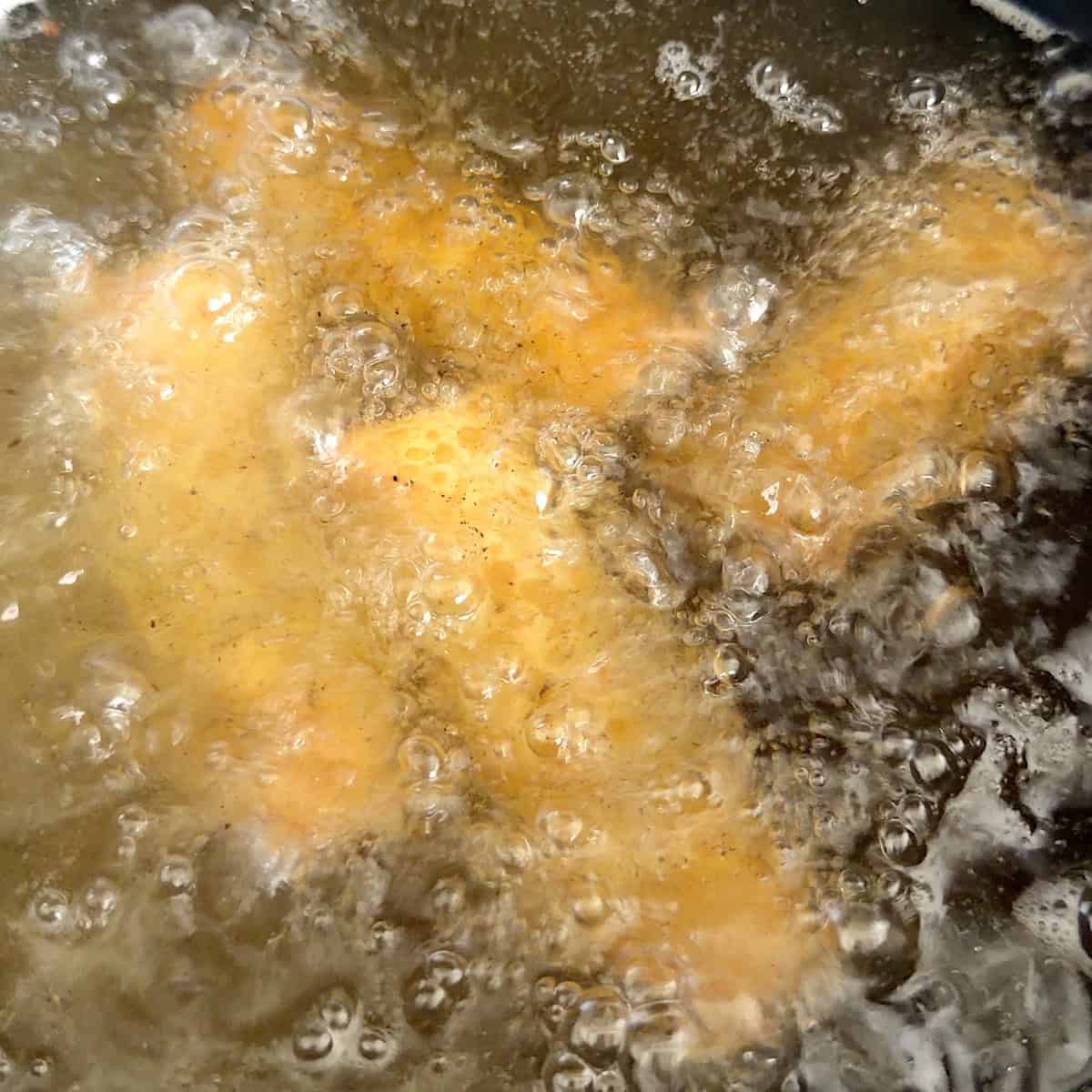 Frying the buffalo chicken egg rolls.