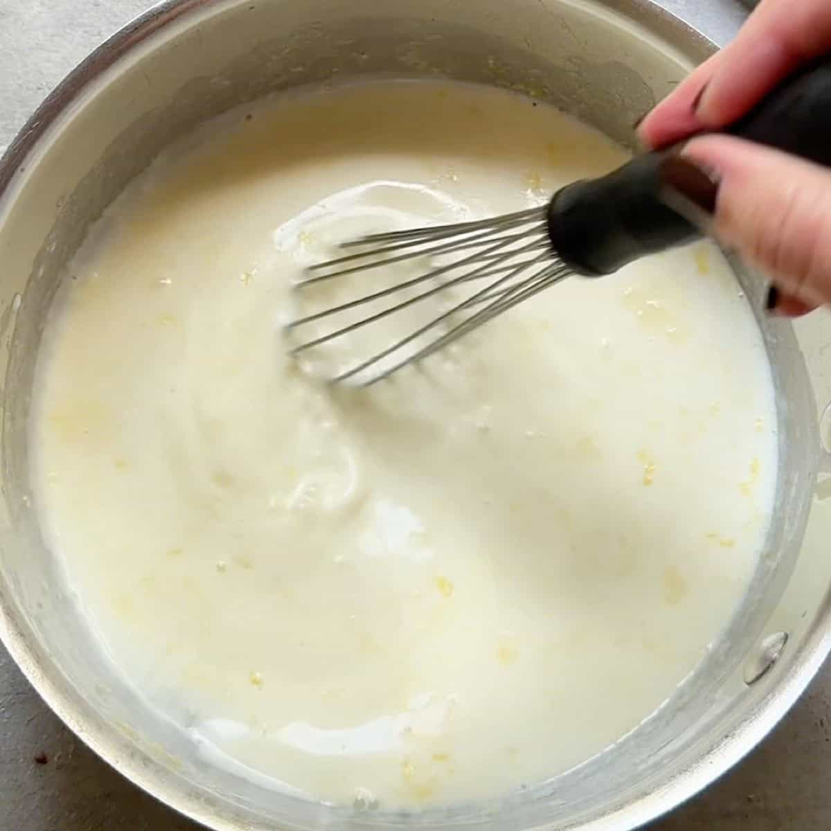 Infusing the cream with sugar and lemon zest.