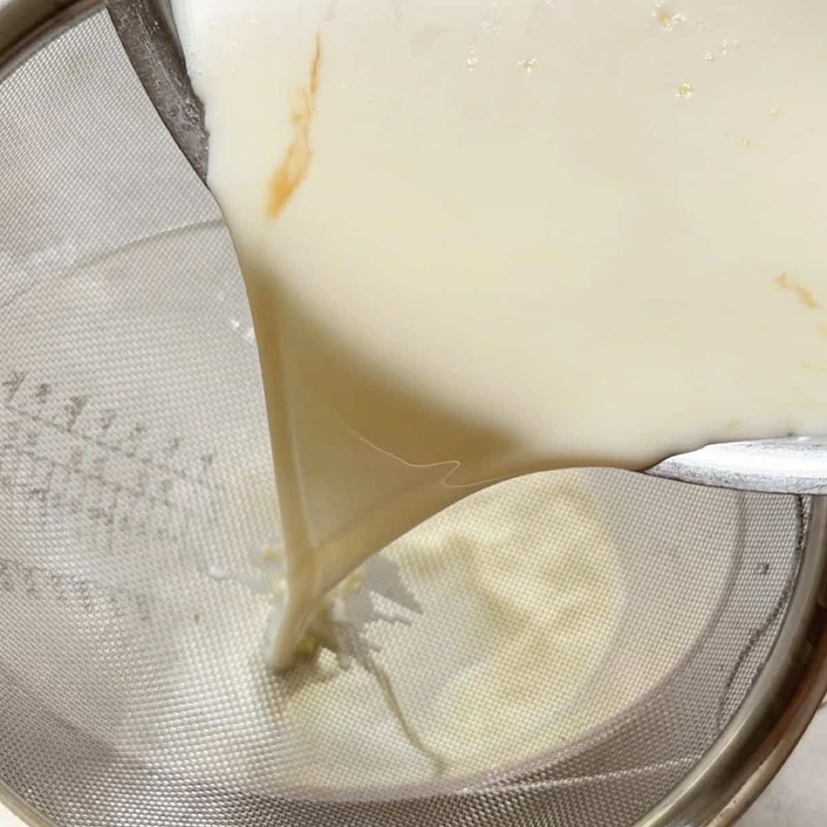 Straining the gelatin panna cotta filling.