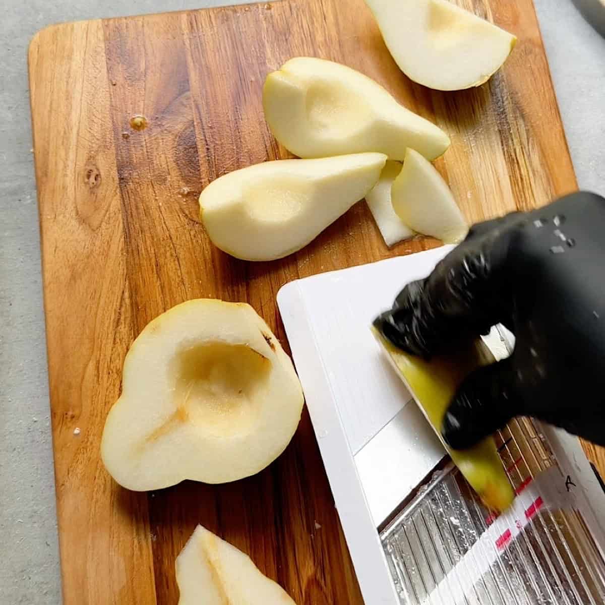 Slicing the pears on a mandolin.