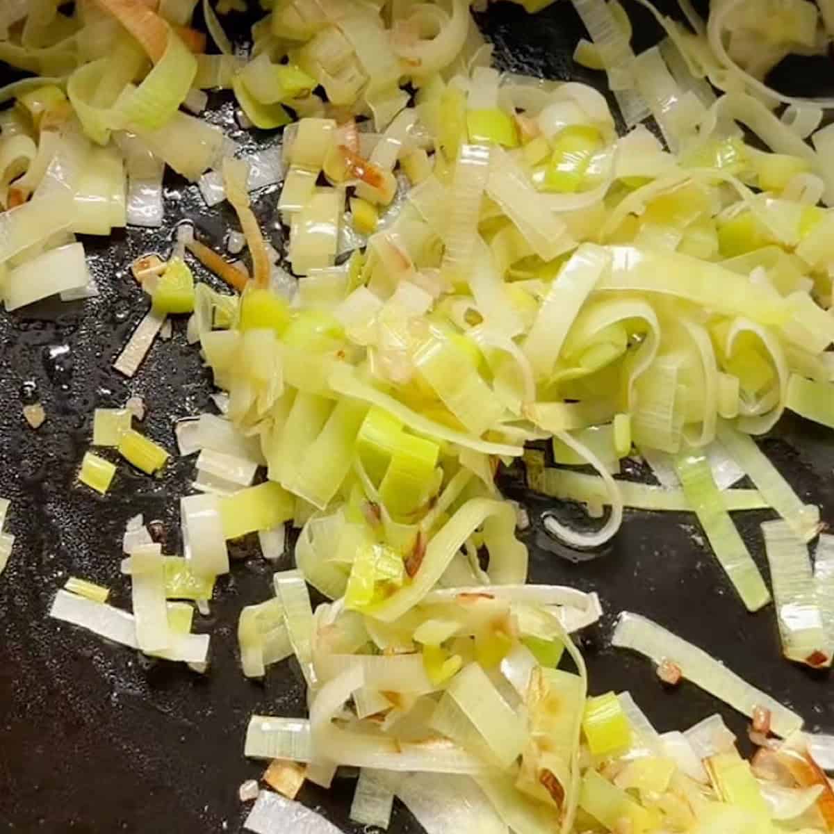 Softened leeks sautéing with shallot and garlic.