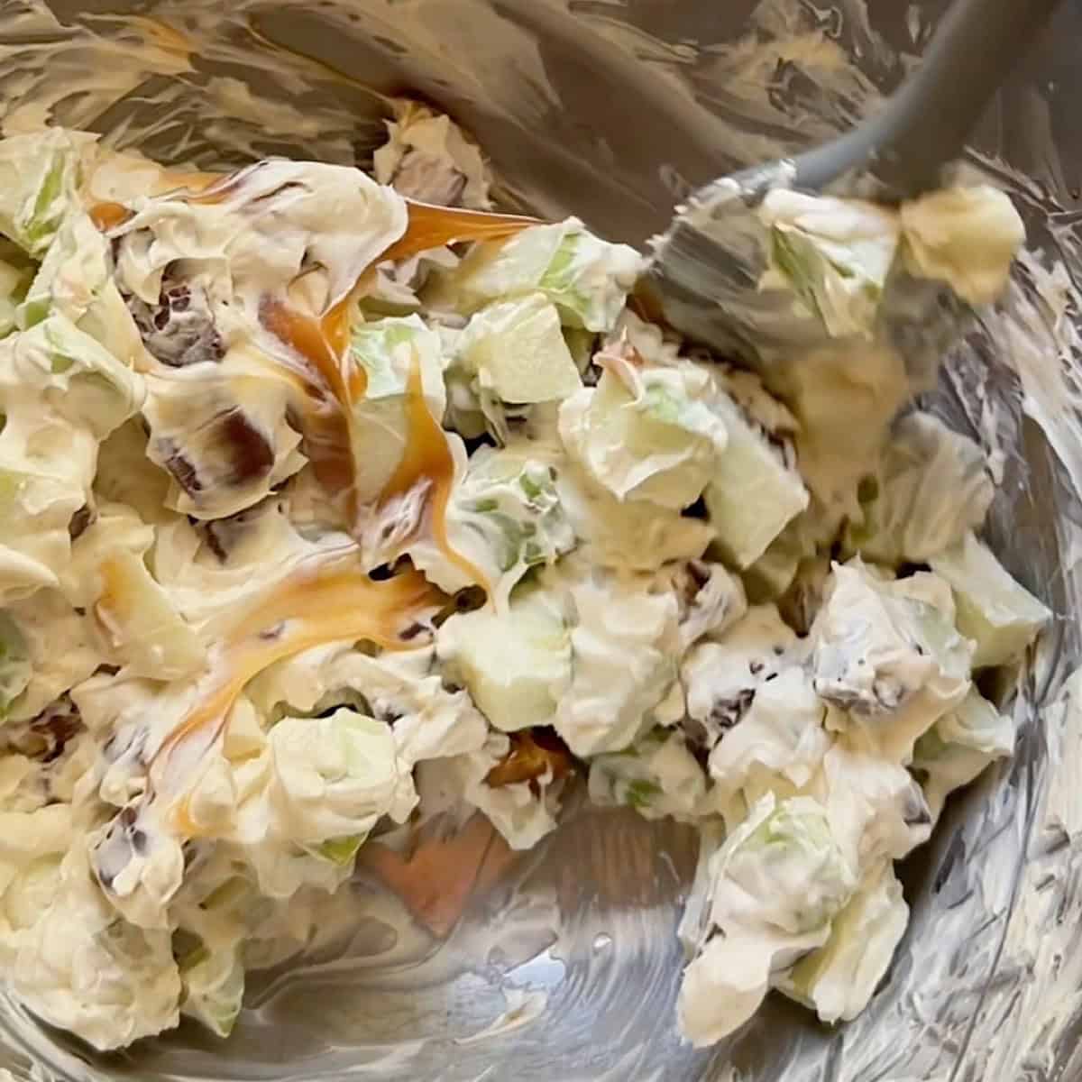 Folding caramel into the Snickers and apple cream cheese filling.